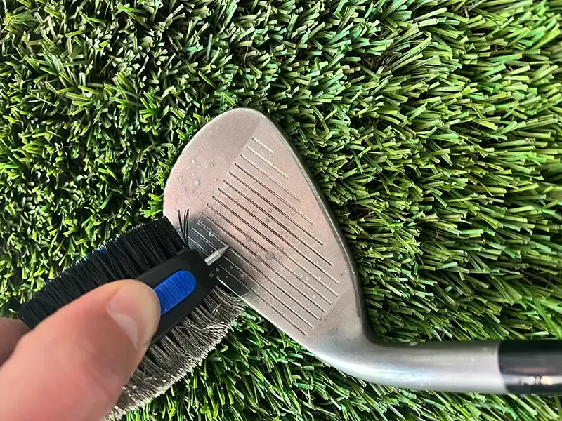 A soft brush cleaning dirt from the grooves of an iron.